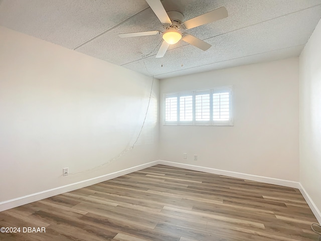 unfurnished room featuring hardwood / wood-style flooring and ceiling fan