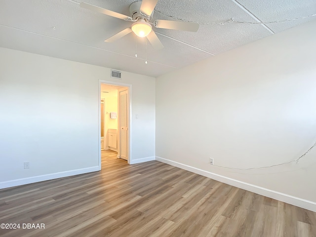 spare room with wood-type flooring and ceiling fan