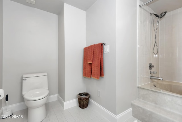 bathroom featuring tile patterned floors, toilet, and tiled shower / bath