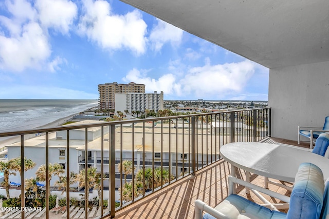 balcony featuring a water view and a beach view