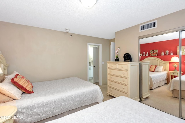 carpeted bedroom featuring a textured ceiling