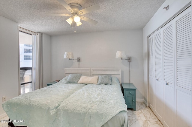 bedroom with a textured ceiling, a closet, and ceiling fan