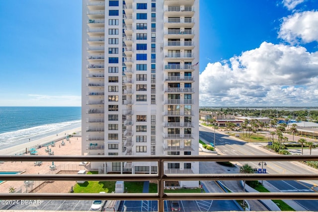 view of building exterior with a water view and a view of the beach