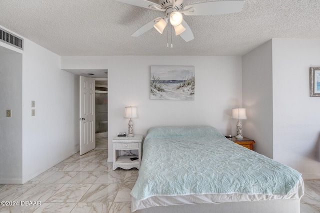 bedroom featuring ceiling fan and a textured ceiling