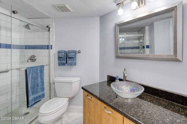 bathroom with vanity, toilet, and walk in shower