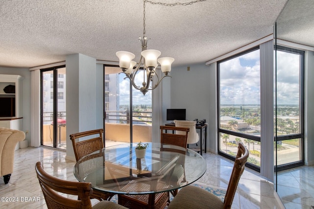 3023 S Atlantic Ave Unit 7070, Daytona Beach, FL 32118 - dining room featuring floor to ceiling windows, a chandelier, a textured ceiling, and light marble finish floors