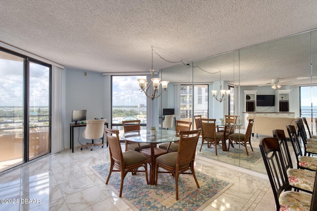 dining space featuring a textured ceiling, expansive windows, and a wealth of natural light