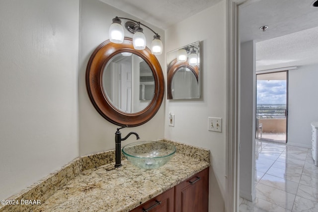 bathroom with vanity and a textured ceiling