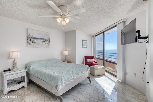 3023 S Atlantic Ave Unit 7070, Daytona Beach, FL 32118 - bedroom with light marble finish flooring, a textured ceiling, and ceiling fan