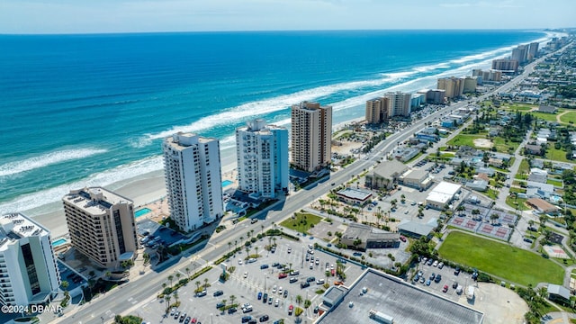 birds eye view of property with a water view and a beach view