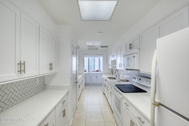 3023 S Atlantic Ave Unit 7070, Daytona Beach, FL 32118 - kitchen featuring white appliances, a sink, backsplash, white cabinetry, and light tile patterned floors