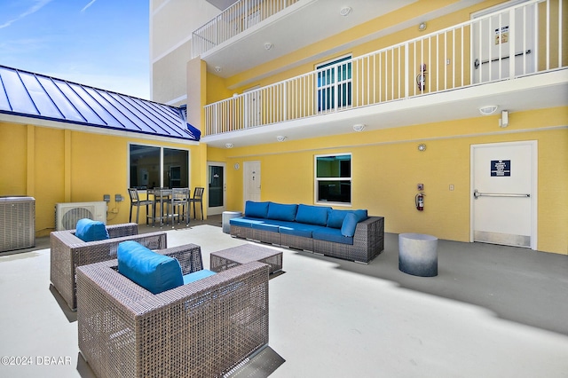 view of patio featuring central AC, a bar, and an outdoor hangout area