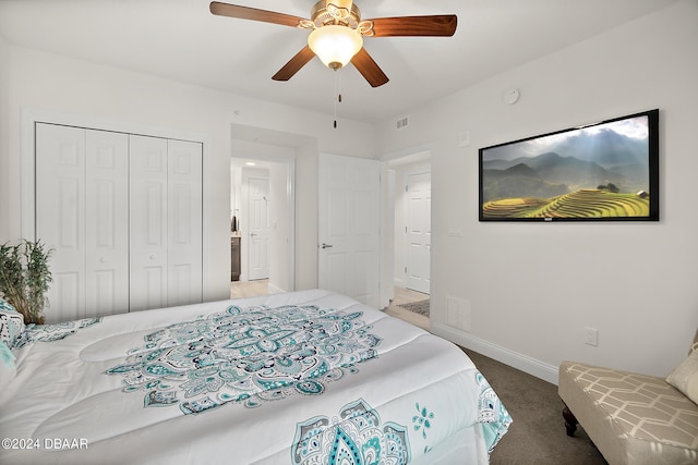 carpeted bedroom featuring ceiling fan and a closet