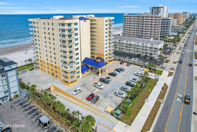 birds eye view of property featuring a water view and a view of the beach