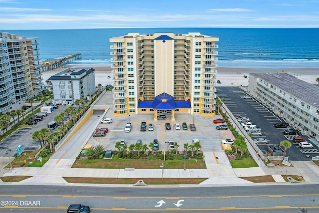 drone / aerial view featuring a water view and a view of the beach