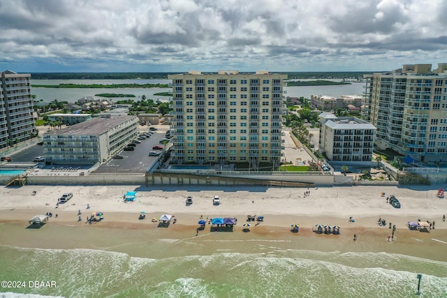 drone / aerial view with a water view and a beach view