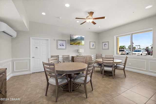 dining space with a wall mounted air conditioner, ceiling fan, and light tile patterned flooring