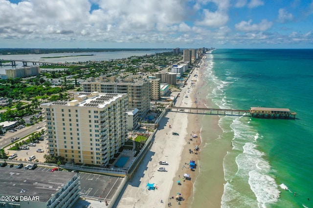 birds eye view of property with a view of the beach and a water view