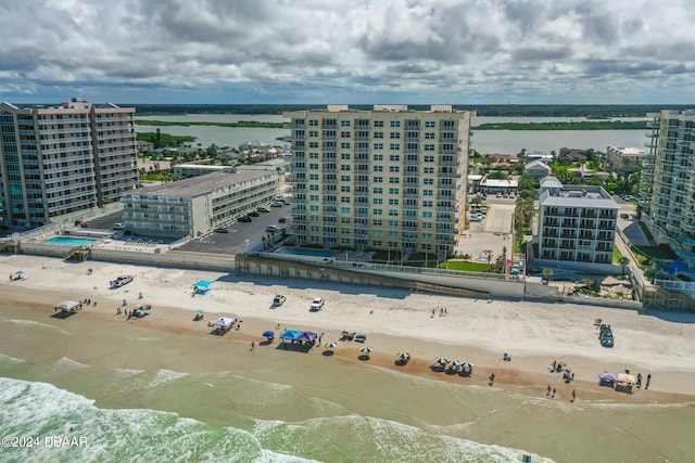 birds eye view of property with a water view and a view of the beach