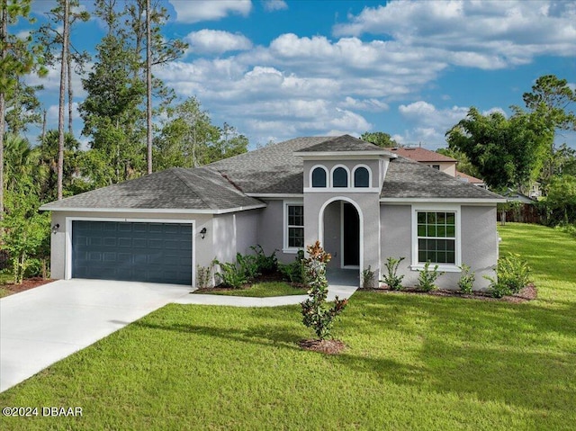 mediterranean / spanish-style home featuring a garage and a front lawn