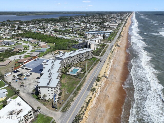 bird's eye view featuring a view of the beach and a water view