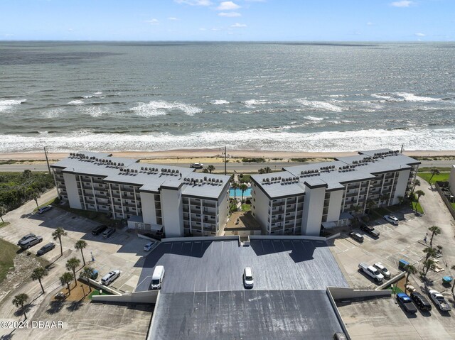 birds eye view of property with a water view and a view of the beach