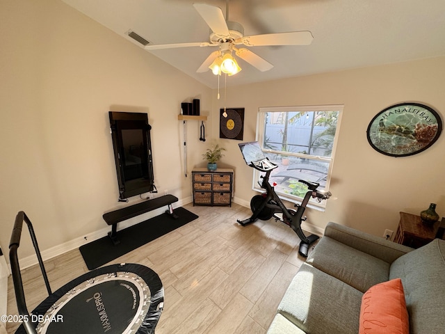 exercise area featuring lofted ceiling, visible vents, ceiling fan, light wood-type flooring, and baseboards