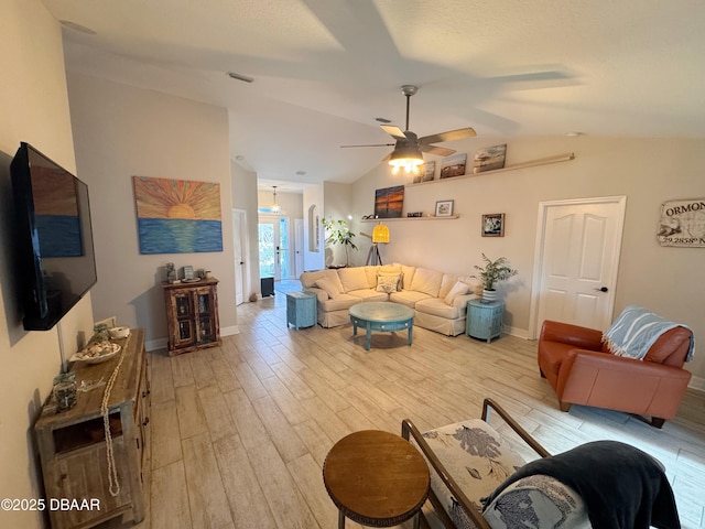 living room with light wood finished floors, baseboards, visible vents, and vaulted ceiling