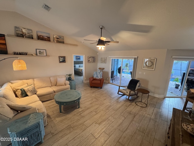 living area featuring a ceiling fan, lofted ceiling, baseboards, and wood finished floors