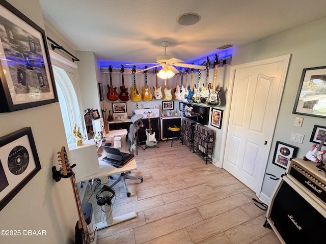 office space featuring a ceiling fan and wood tiled floor