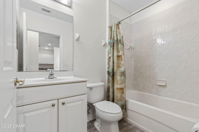 bathroom with visible vents, toilet, wood finished floors, shower / bath combination with curtain, and vanity