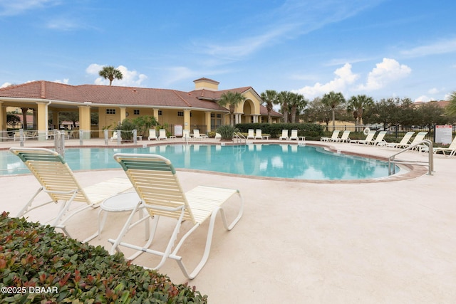 pool with fence and a patio