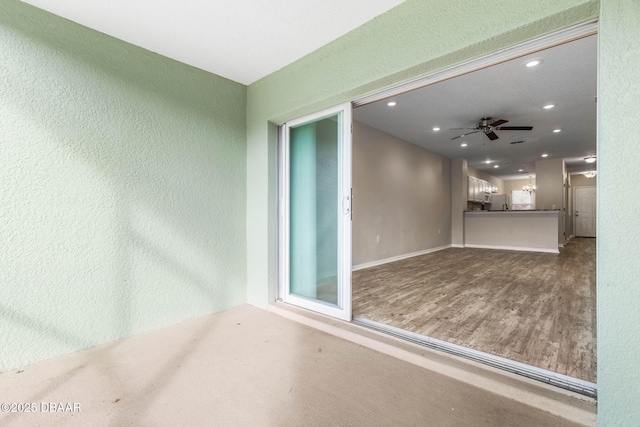 empty room with a ceiling fan, recessed lighting, a textured wall, and wood finished floors