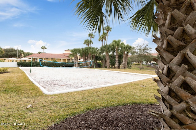 surrounding community with fence, a lawn, and volleyball court