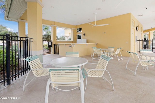 view of patio / terrace featuring visible vents, outdoor dining area, and a ceiling fan