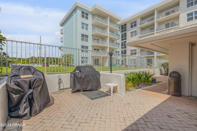 view of patio / terrace featuring grilling area and a balcony