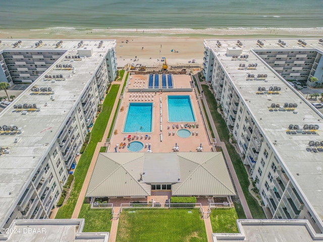 bird's eye view with a water view and a beach view