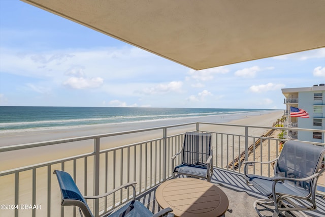 balcony with a view of the beach and a water view