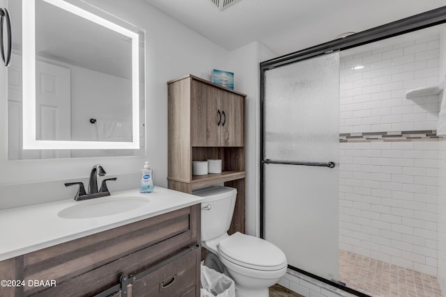 bathroom featuring vanity, toilet, and an enclosed shower