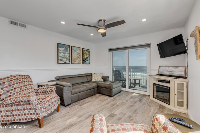 living room featuring ceiling fan and light hardwood / wood-style flooring