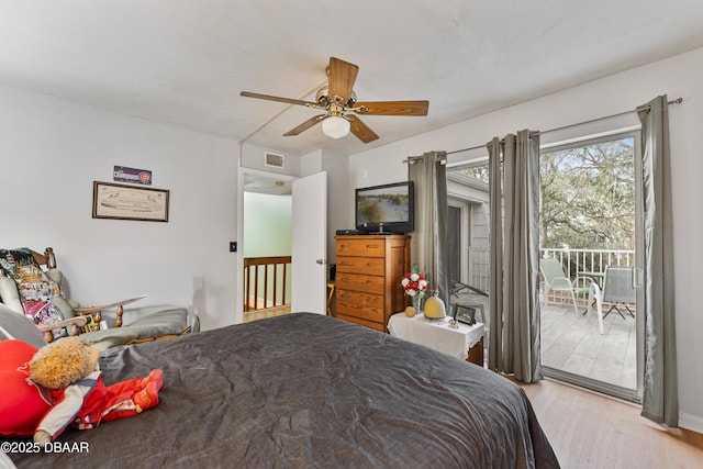 bedroom with visible vents, wood finished floors, access to exterior, and a ceiling fan