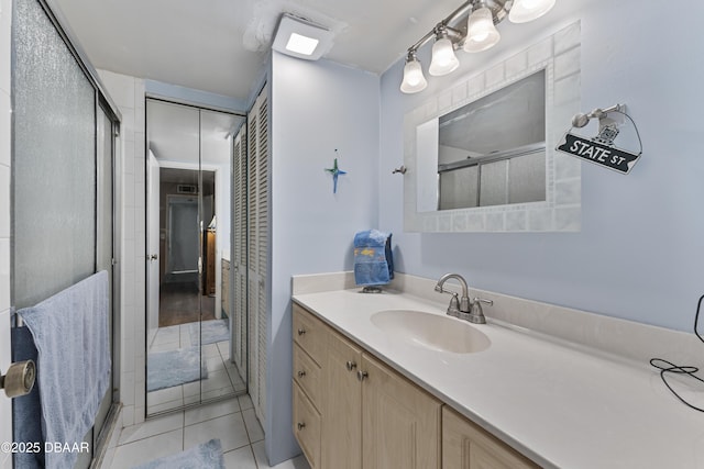 bathroom with vanity, tile patterned floors, and a stall shower