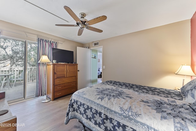 bedroom with a ceiling fan, access to outside, wood finished floors, and visible vents