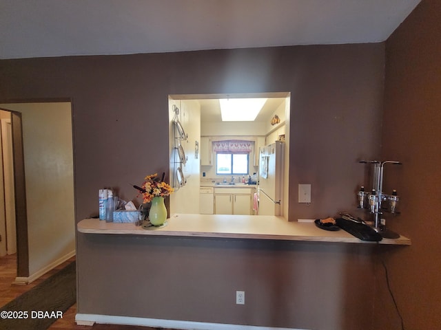 3557 Forest Branch Dr Unit B, Port Orange, FL 32129 - kitchen with freestanding refrigerator, wood finished floors, and a peninsula