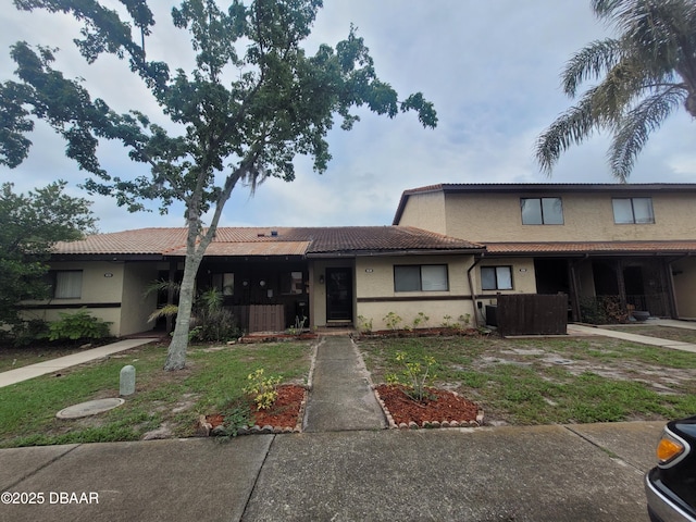 3557 Forest Branch Dr Unit B, Port Orange, FL 32129 - view of property with stucco siding and a tiled roof