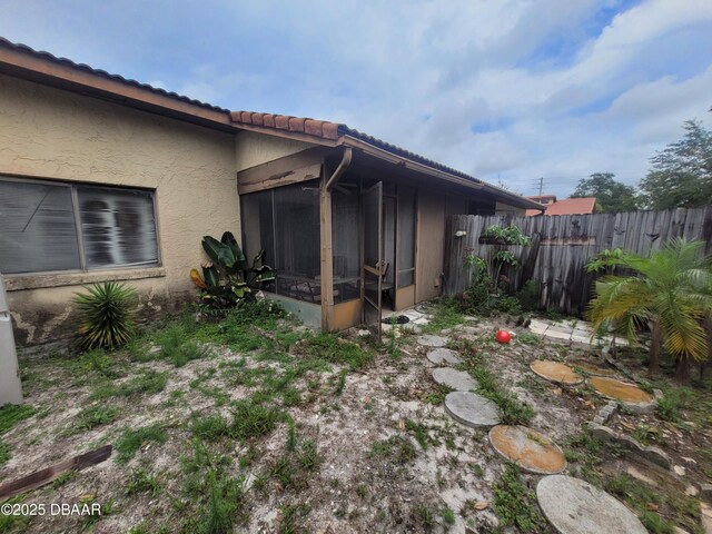 3557 Forest Branch Dr Unit B, Port Orange, FL 32129 - view of side of property featuring a sunroom, a tiled roof, and stucco siding