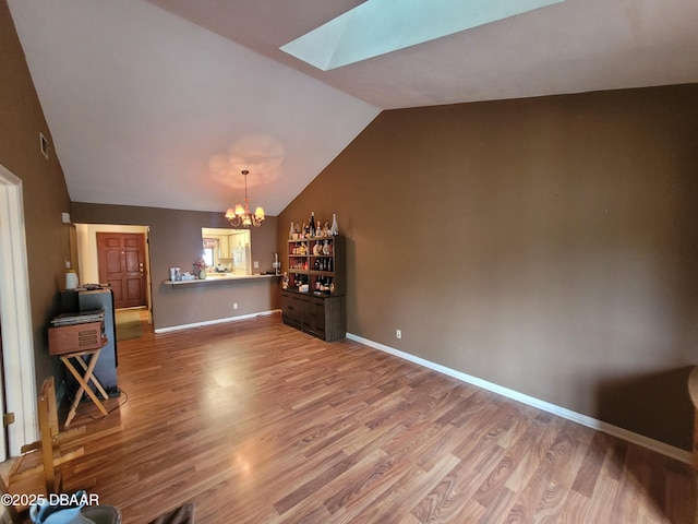 3557 Forest Branch Dr Unit B, Port Orange, FL 32129 - living area featuring a chandelier, a skylight, lofted ceiling, and wood finished floors