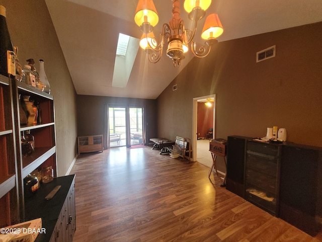 3557 Forest Branch Dr Unit B, Port Orange, FL 32129 - living room featuring a skylight, wood finished floors, high vaulted ceiling, and a chandelier