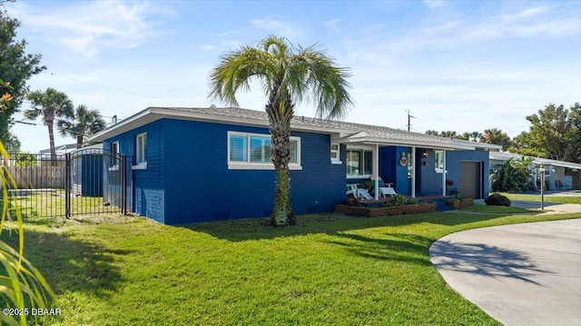 single story home featuring a porch, a front yard, concrete driveway, and fence