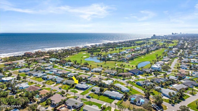 drone / aerial view with a water view, a residential view, and golf course view